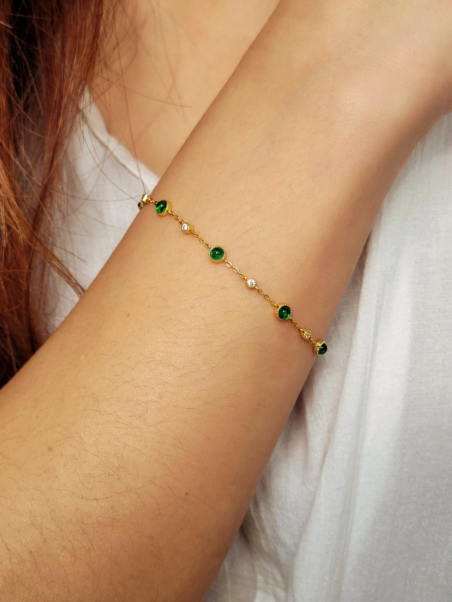 Model wearing a green gemstone bracelet in gold plated sterling silver, perfect jewellery gift for her.