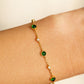 Dainty 18k gold vermeil station bracelet with green onyx and clear CZ gemstones worn on a wrist.