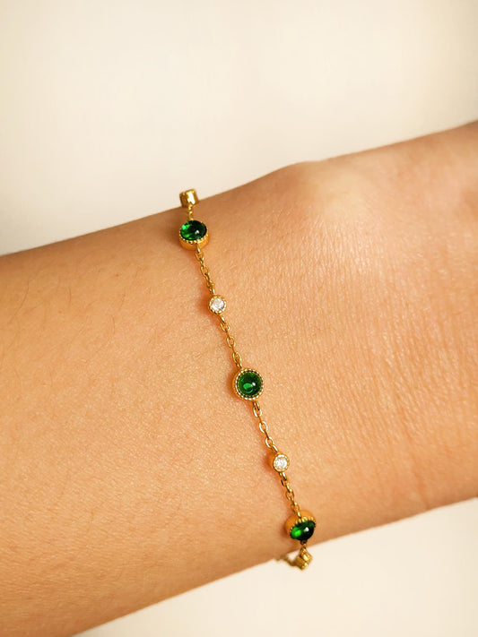 Dainty 18k gold vermeil station bracelet with green onyx and clear CZ gemstones worn on a wrist.