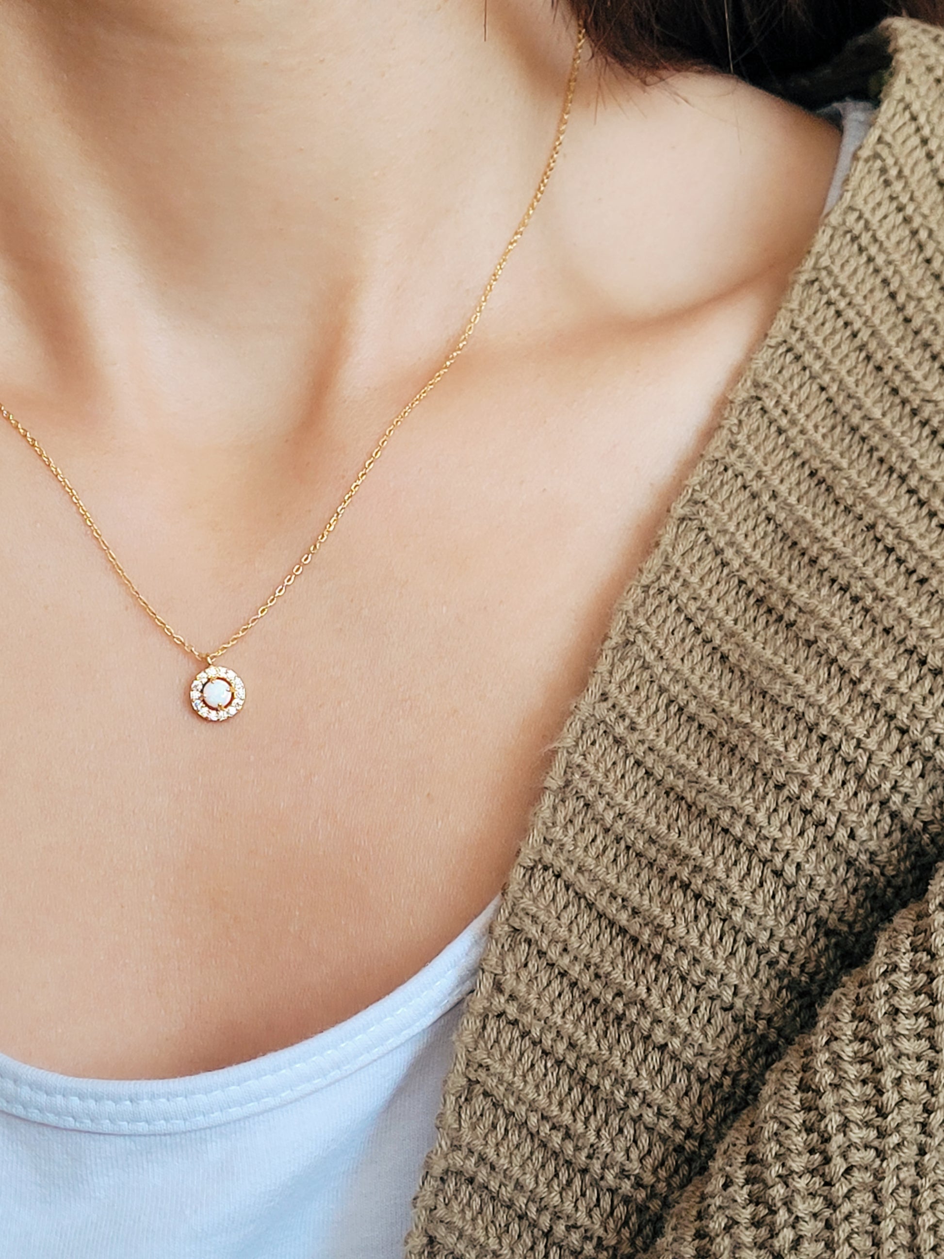 A woman wearing a high quality delicate opal necklace.