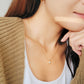 A woman wearing the Opal Necklace and pair with dainty Gold Hoop Earrings.