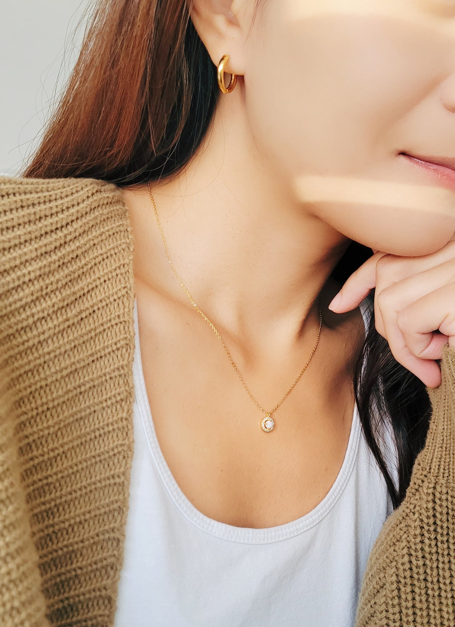 A woman wearing the Opal Necklace and pair with dainty Gold Hoop Earrings.