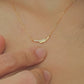 Close up of a lady wearing a gold necklace crafted in gold plated sterling silver with shimmering diamond.