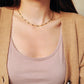 Close-up of a 22k gold vermeil choker necklace with black onyx beads worn around the neck. Crafted in 22k gold plated over sterling silver and natural gemstone. Perfect gift for her.
