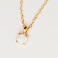 A gold chain necklace with a small oval pendant featuring a white opal gemstone in a gold bezel setting, shown against a plain light background.