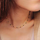 Close-up of a 22k gold vermeil choker necklace with black onyx beads worn around the neck. Crafted in 22k gold plated over sterling silver and natural gemstone. Perfect gift for her.