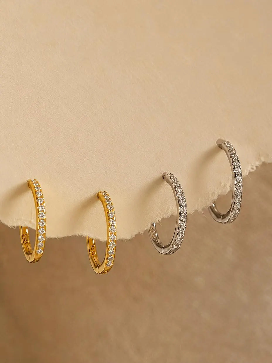 Set of  pavé diamond huggie hoop earrings featuring tiny crystals set in gold vermeil or sterling silver huggies. Minimalist and versatile jewellery for everyday.