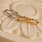 Dainty sterling silver and gold vermeil pavé diamond-like huggie hoop earrings, studded with small, clear cubic zirconia stones to add sparkle.