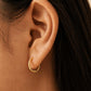 Dainty gold huggie hoop earrings featuring pavé-set lab grown diamond along the front, crafted in 18k gold vermeil. Minimalist earrings for everyday wear.