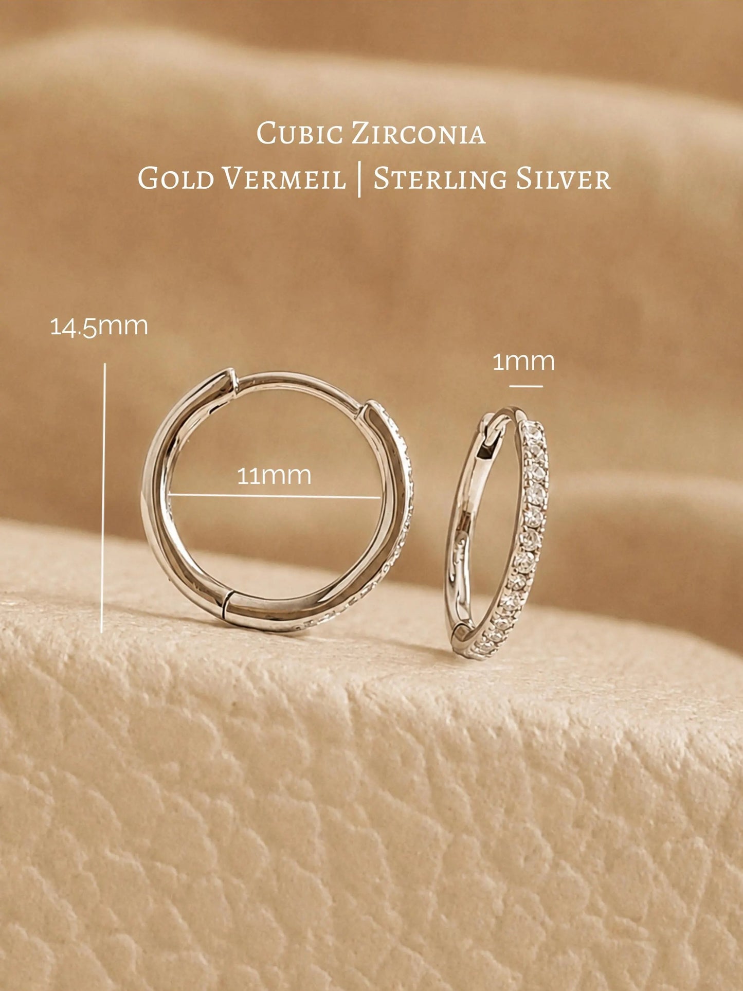 A pair of  delicate 925 sterling silver huggie hoop earrings featuring sparkling clear cubic zirconia stones on a jewellery box, perfect birthday gift for her 