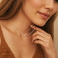 Close-up of a woman wearing a delicate, minimalist choker necklace made of tiny white glass pearls and a textured row of shimmering sterling silver nuggets.