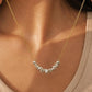 Gold necklace with a silver pendant worn by a person