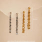 Two silver and two 18k gold-plated sterling silver tassel dangles hanging on a beige background with a 32mm measurement guide, showcasing the delicate flat-link fringe chain style.