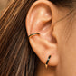 Close-up of black enamel gold vermeil ear cuff worn on the cartilage with no piercing required.