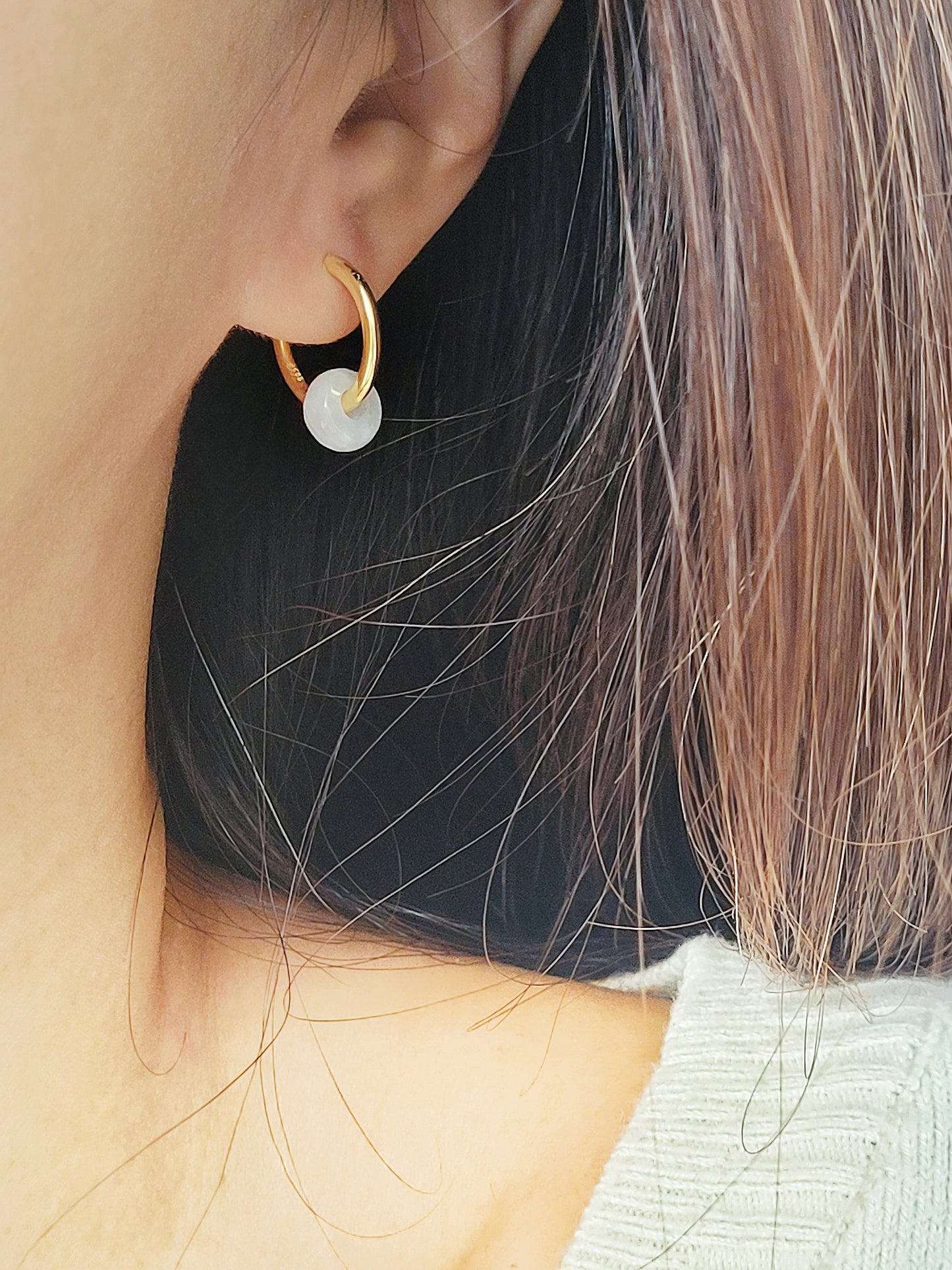 Elegant white jade huggie hoops crafted from genuine natural gemstones and 18ct gold plated sterling silver, perfect for adding a touch of sophistication.