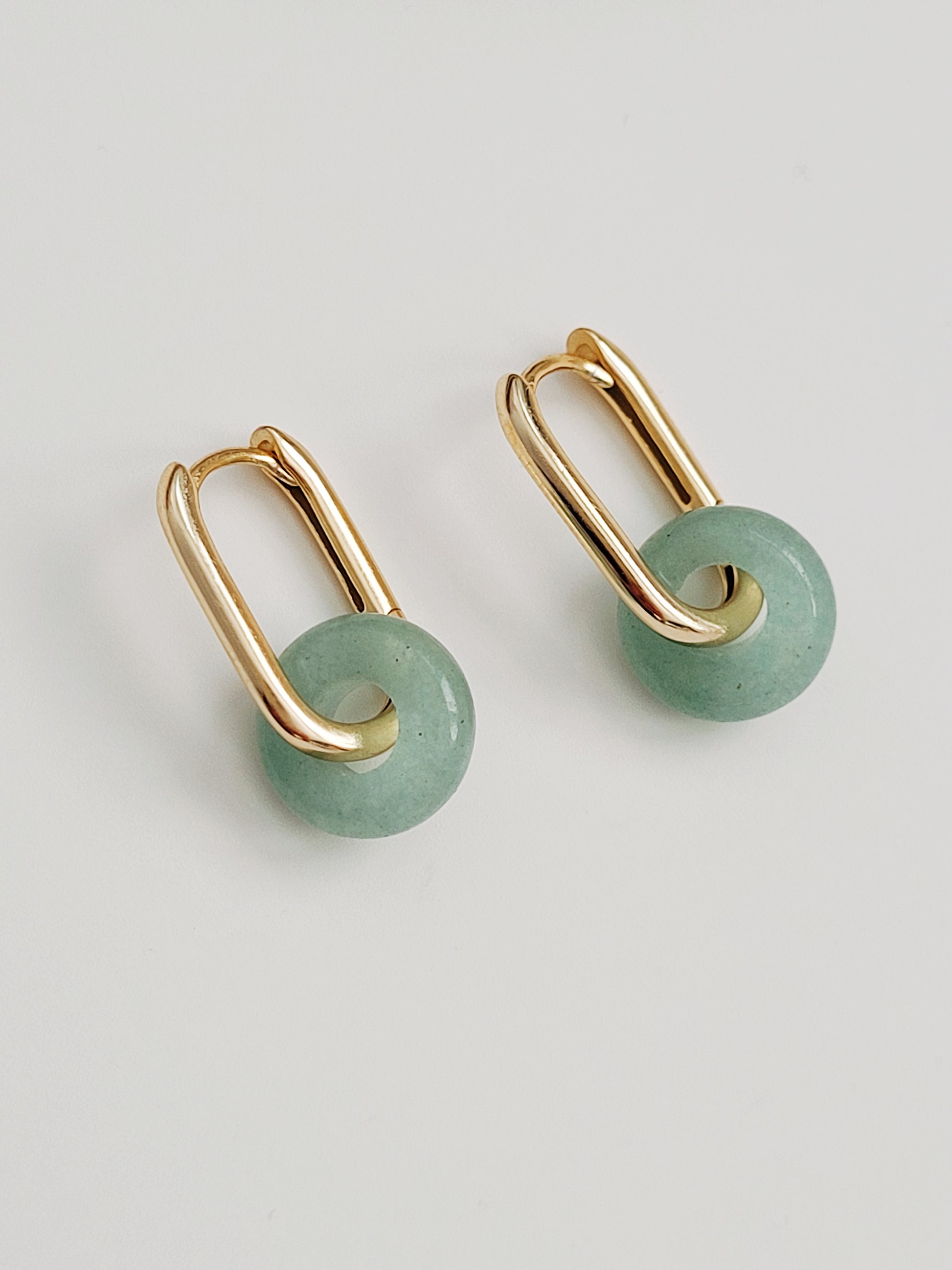 Close-up of a pair of green jade link hoop earrings, showcasing their elegant and minimalist design.