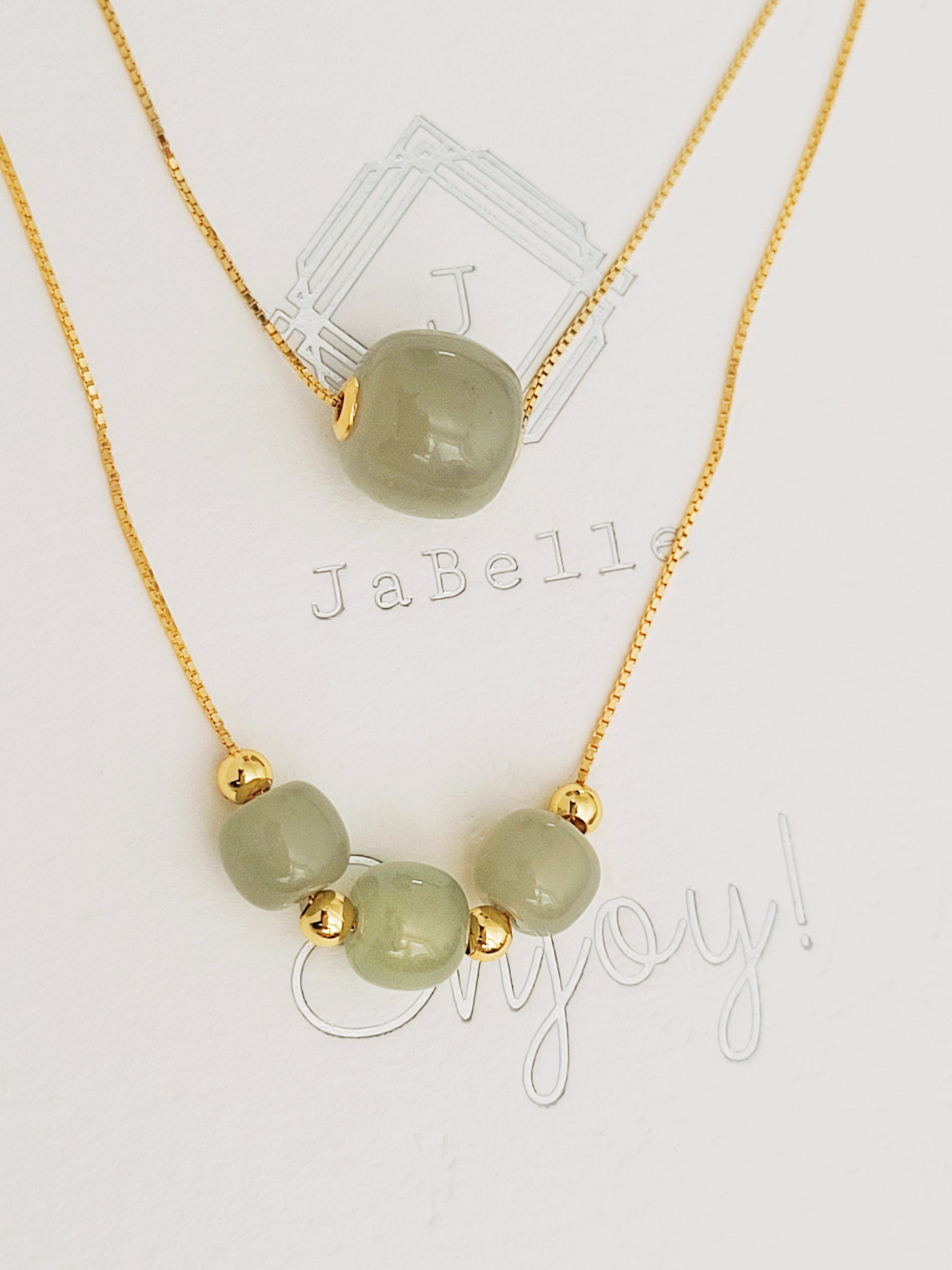 Adjustable gold necklace with three soft green jade gemstone beads, combining natural beauty with luxurious gold accents for a meaningful gift for women.