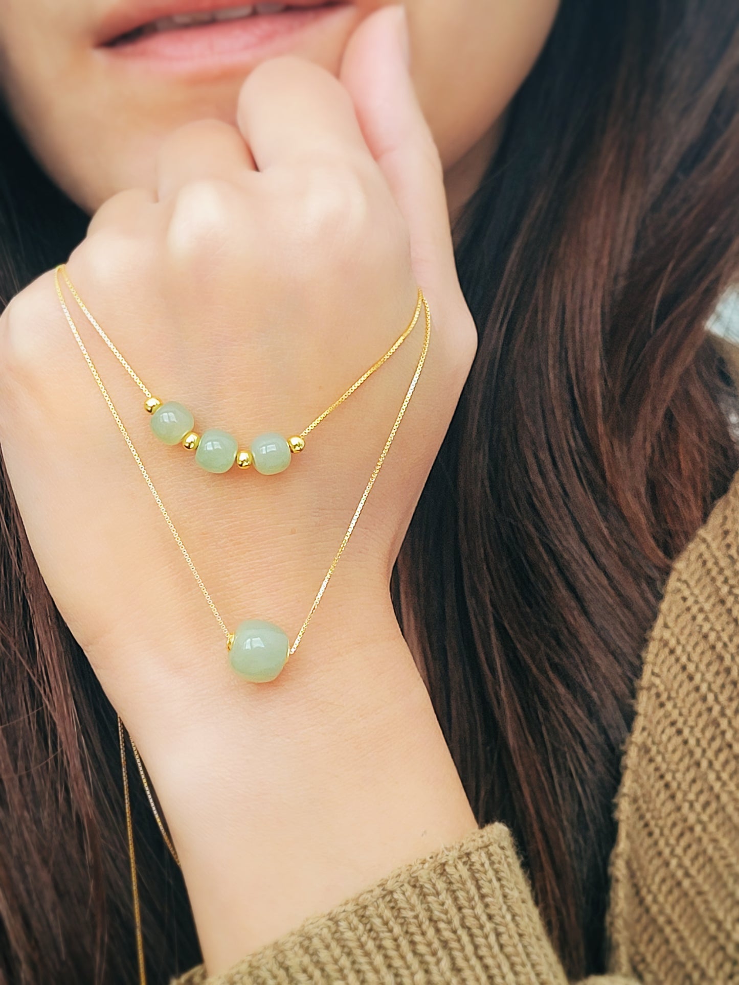 Adjustable gold necklace with soft green jade gemstone pendant, combining natural beauty with luxurious gold accents for a meaningful gift for women.