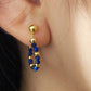 Gold and blue lapis lazuli beaded earring worn on an ear