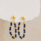 Gold and blue beaded hoop earrings on a neutral background, perfect jewellery gift for her