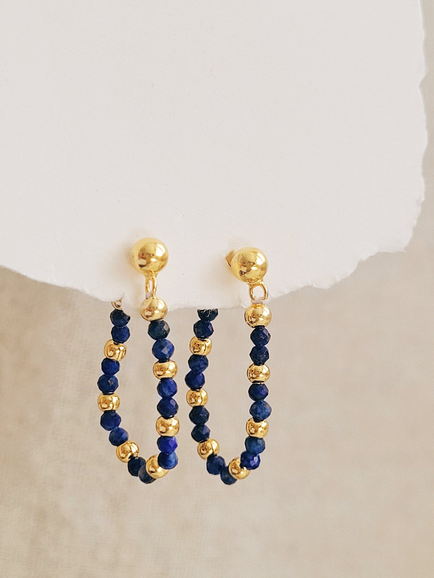 Gold and blue beaded hoop earrings on a neutral background, perfect jewellery gift for her