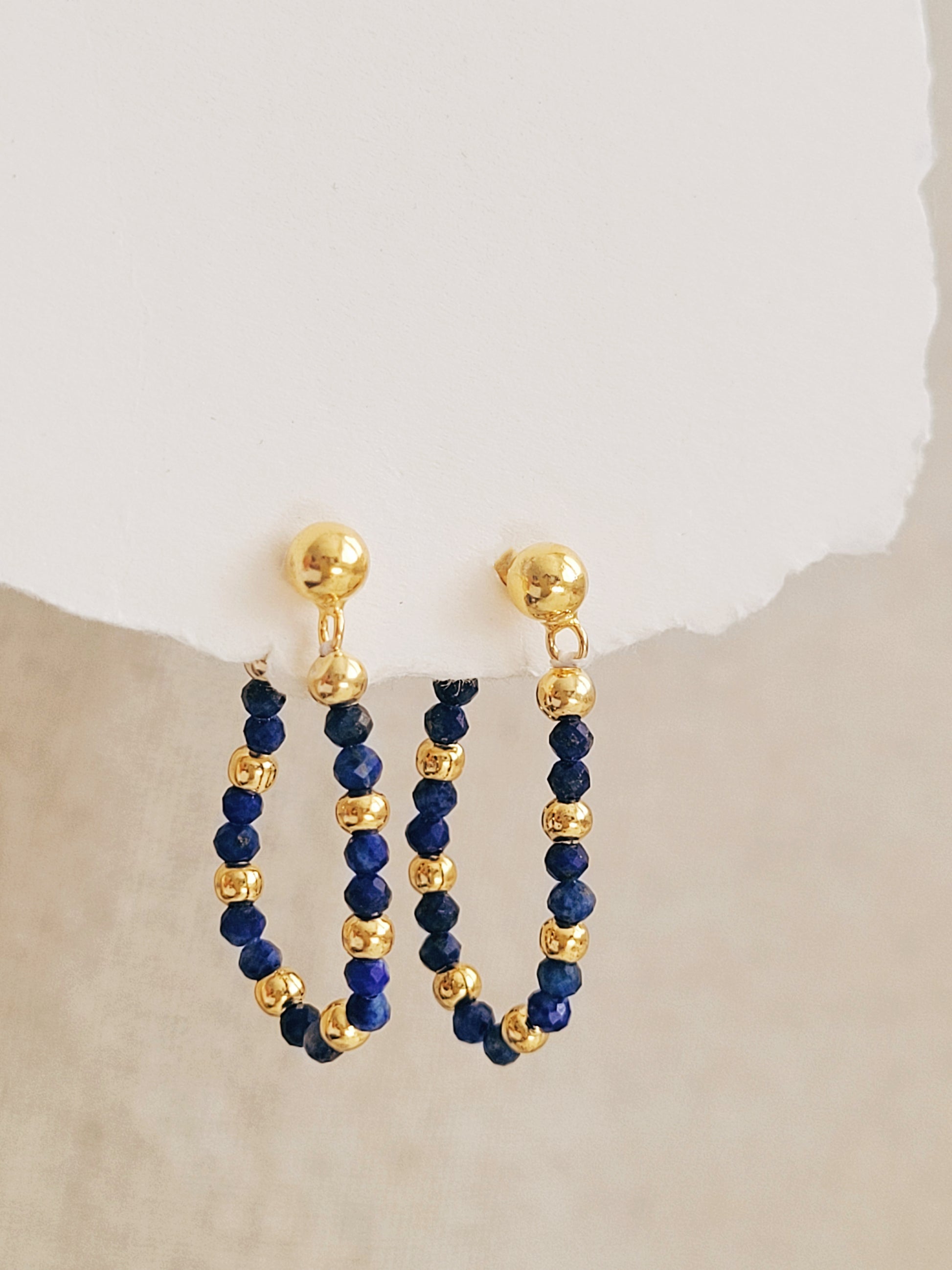 Gold and blue beaded hoop earrings on a neutral background, perfect jewellery gift for her