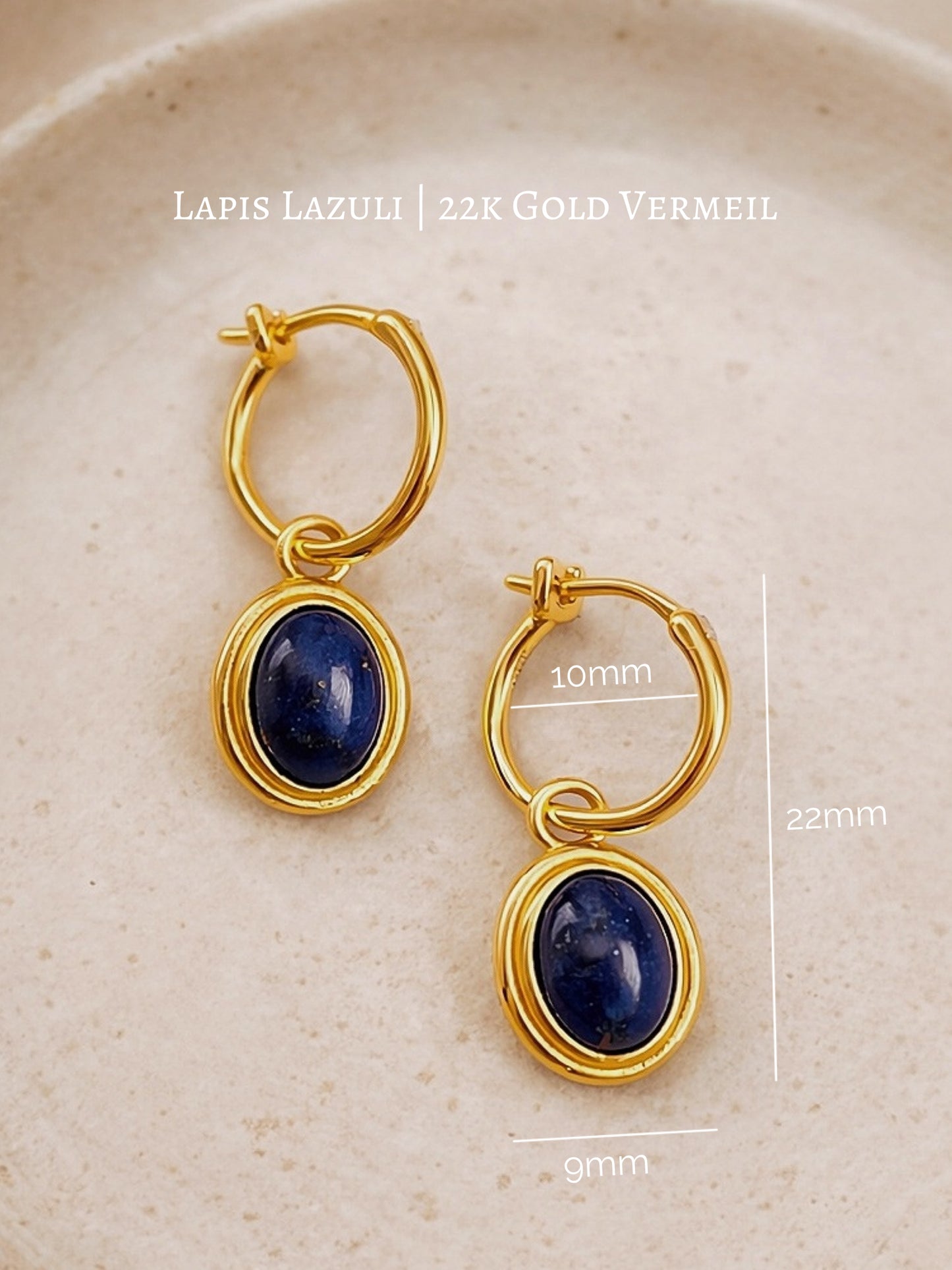 Gold hoop earrings crafted in 22k gold vermeil with lapis lazuli stones on a beige background