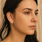 Woman wearing the mini blue enamel bead huggie earrings, dainty small earrings for everyday wear