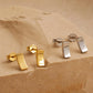 Gold and silver bar stud earrings, minimalist rectangle stud earrings in gold vermeil and sterling silver on an aesthetic beige color stone