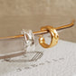 Gold and silver minimalist ear cuff earring hang on a plate