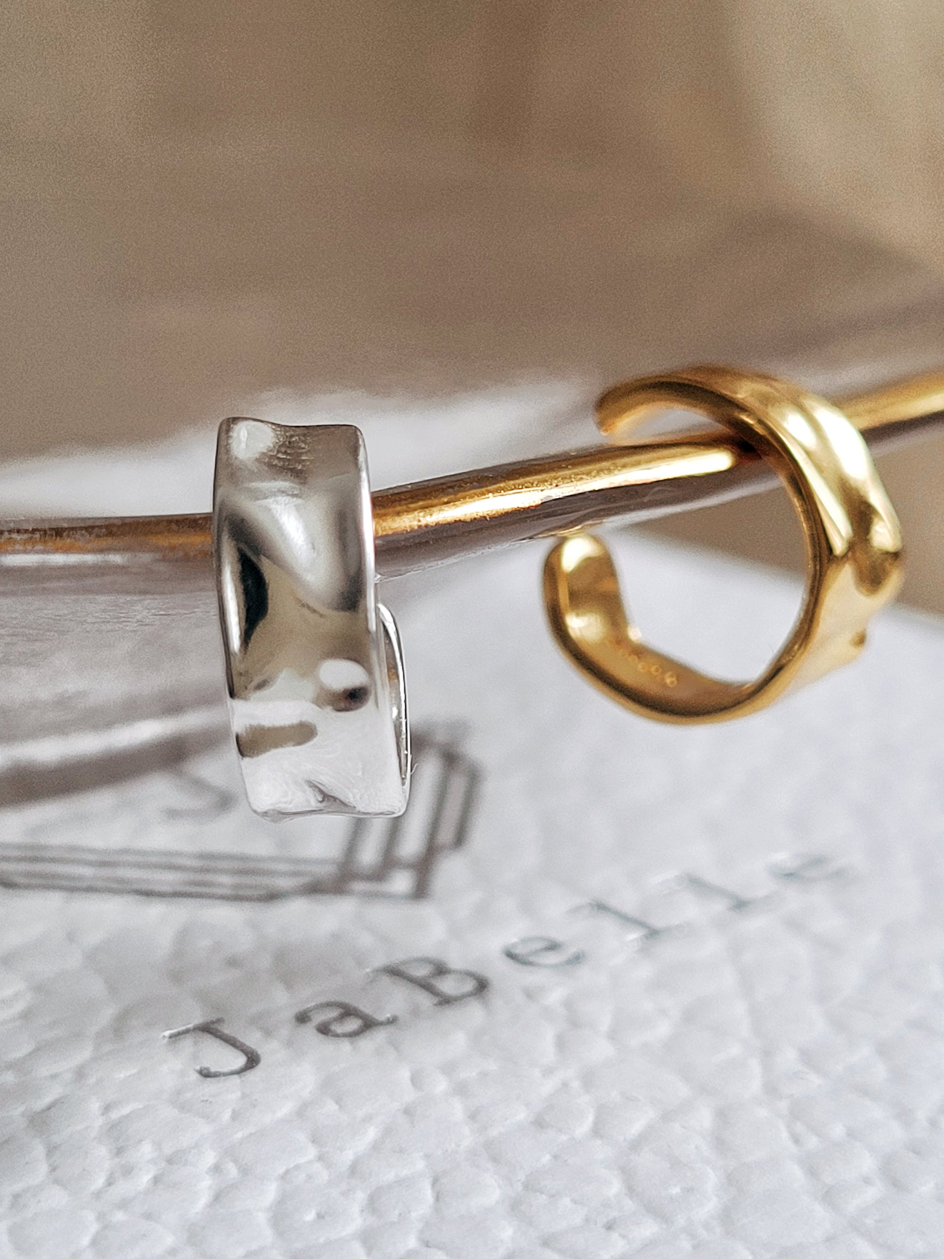 Close up of a hammered minimalist sterling silver cuff earring