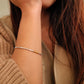 Close-up of a girl wearing a delicate bracelet on her wrist.