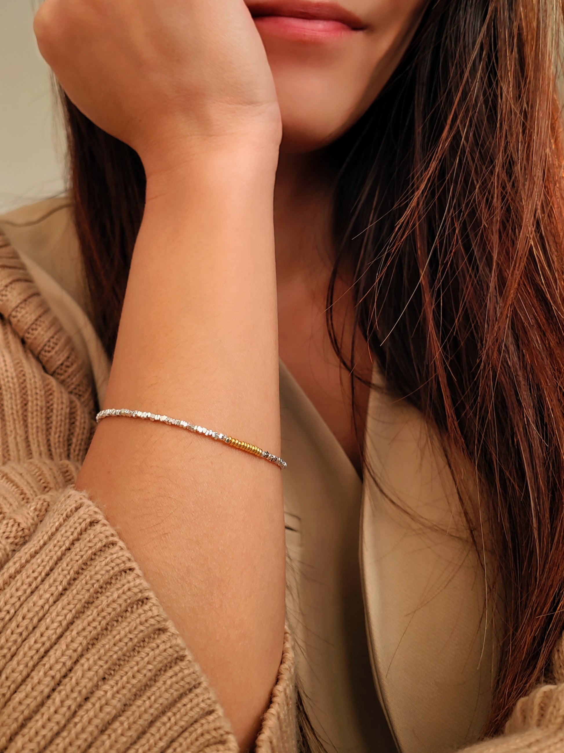 Close-up of a girl wearing a delicate bracelet on her wrist.
