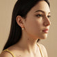 Woman with long dark hair wearing a moonstone stud earring featuring a dangly freshwater pearl drop, perfect birthday gift for june girl.