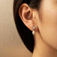 Dainty moonstone pearl drop earrings crafted in 925 sterling silver worn on a woman ear, minimalist bridal jewellery.
