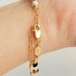 Close up of the clasp of a gemstone bracelet on a model wrist