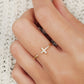 A luxurious gold cross ring featuring a pave cross and a hidden gem, exuding sophistication and charm.