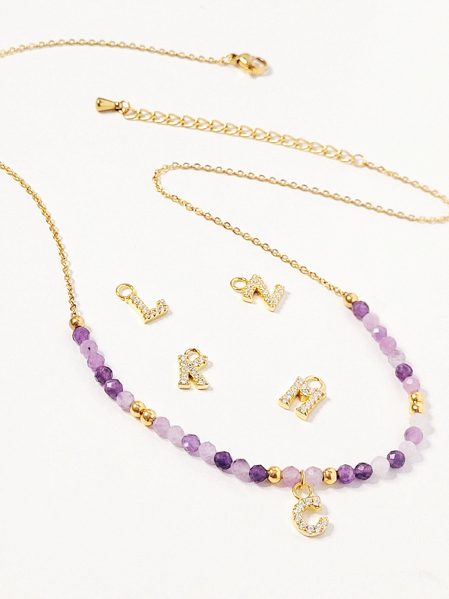 Personalized amethyst beaded necklace with custom gold letter charm, perfect as a birthstone or initial jewelry gift.