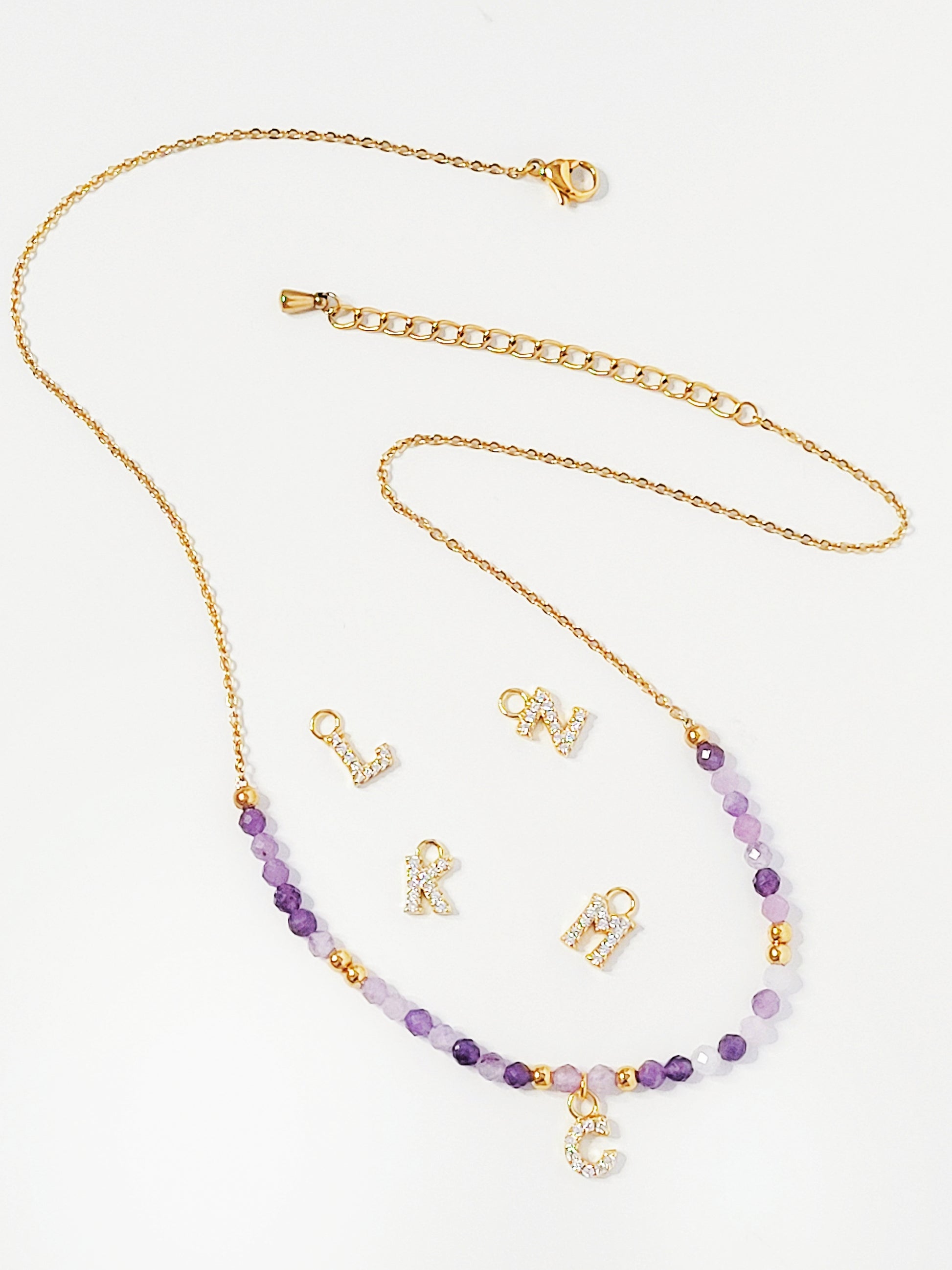 Personalized amethyst beaded necklace with custom gold letter charm, perfect as a birthstone or initial jewelry gift.