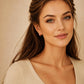Model wearing pink enamel huggie hoop earrings in gold vermeil, dainty minimalist small gold hoop earrings.