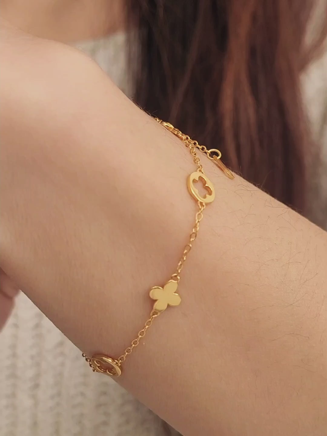 A dainty gold bracelet featuring gold clover charms, crafted in gold plated sterling silver.
