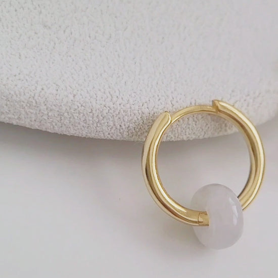 Elegant white jade huggie hoops crafted from genuine natural gemstones and 18ct gold plated sterling silver, perfect for adding a touch of sophistication.