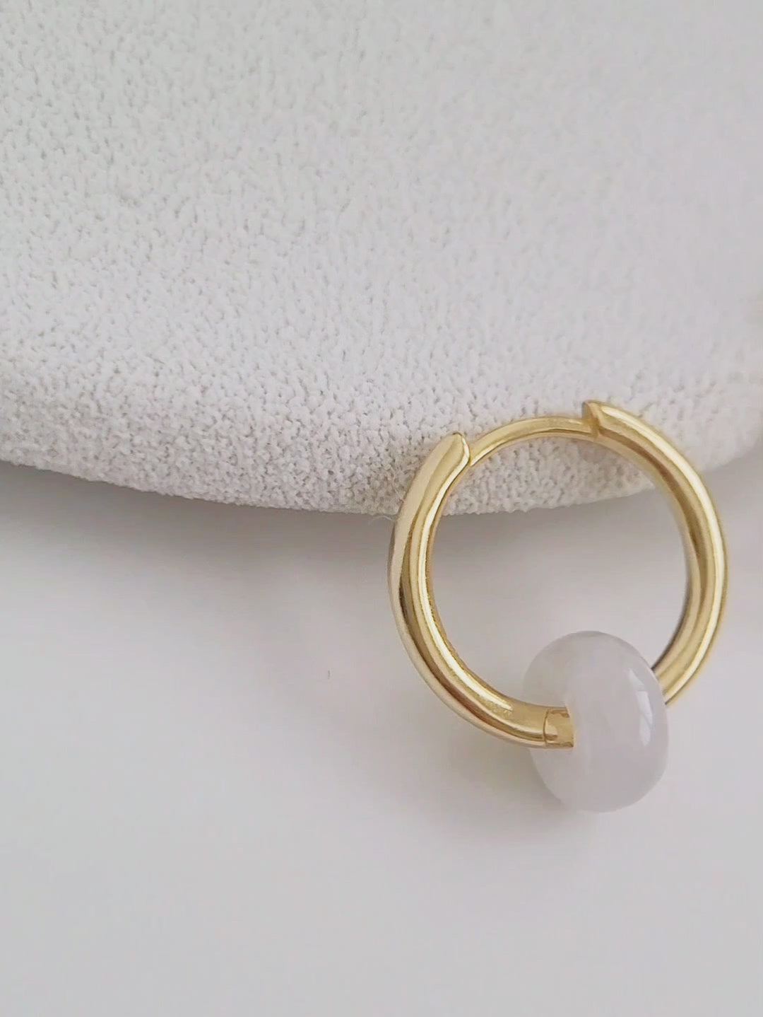 Elegant white jade huggie hoops crafted from genuine natural gemstones and 18ct gold plated sterling silver, perfect for adding a touch of sophistication.