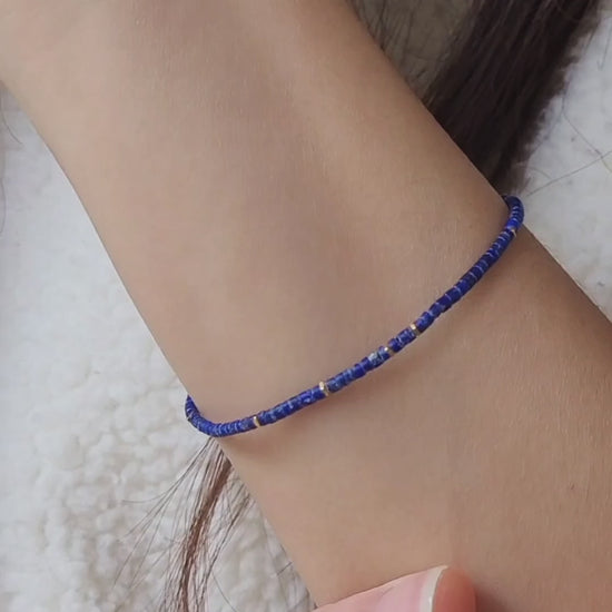 A minimalist gemstone bracelet featuring high-quality 2mm royal blue Lapis Lazuli beads paired with 18k gold vermeil accents, creating a delicate and timeless design perfect for stacking or wearing alone.