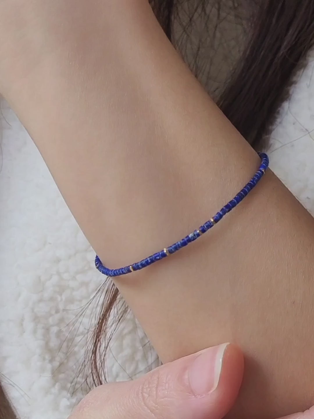 A minimalist gemstone bracelet featuring high-quality 2mm royal blue Lapis Lazuli beads paired with 18k gold vermeil accents, creating a delicate and timeless design perfect for stacking or wearing alone.