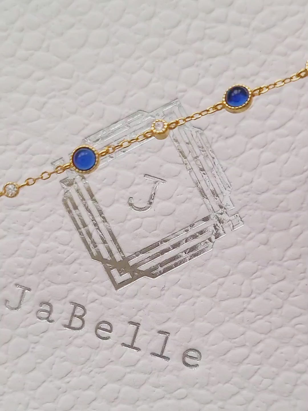 A luxurious 18ct gold plated over sterling silver chain adorned with exquisite blue sapphires and sparkling zircons, showcasing a stunning sapphire station bracelet design.