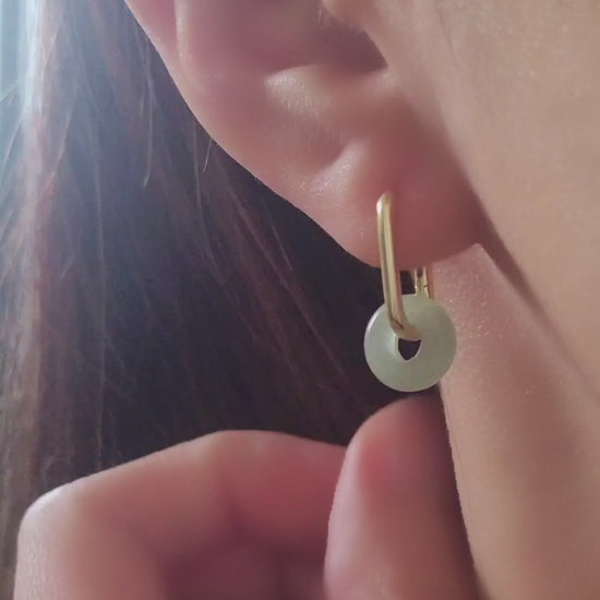 Close-up of a pair of green jade link hoop earrings, showcasing their elegant and minimalist design.