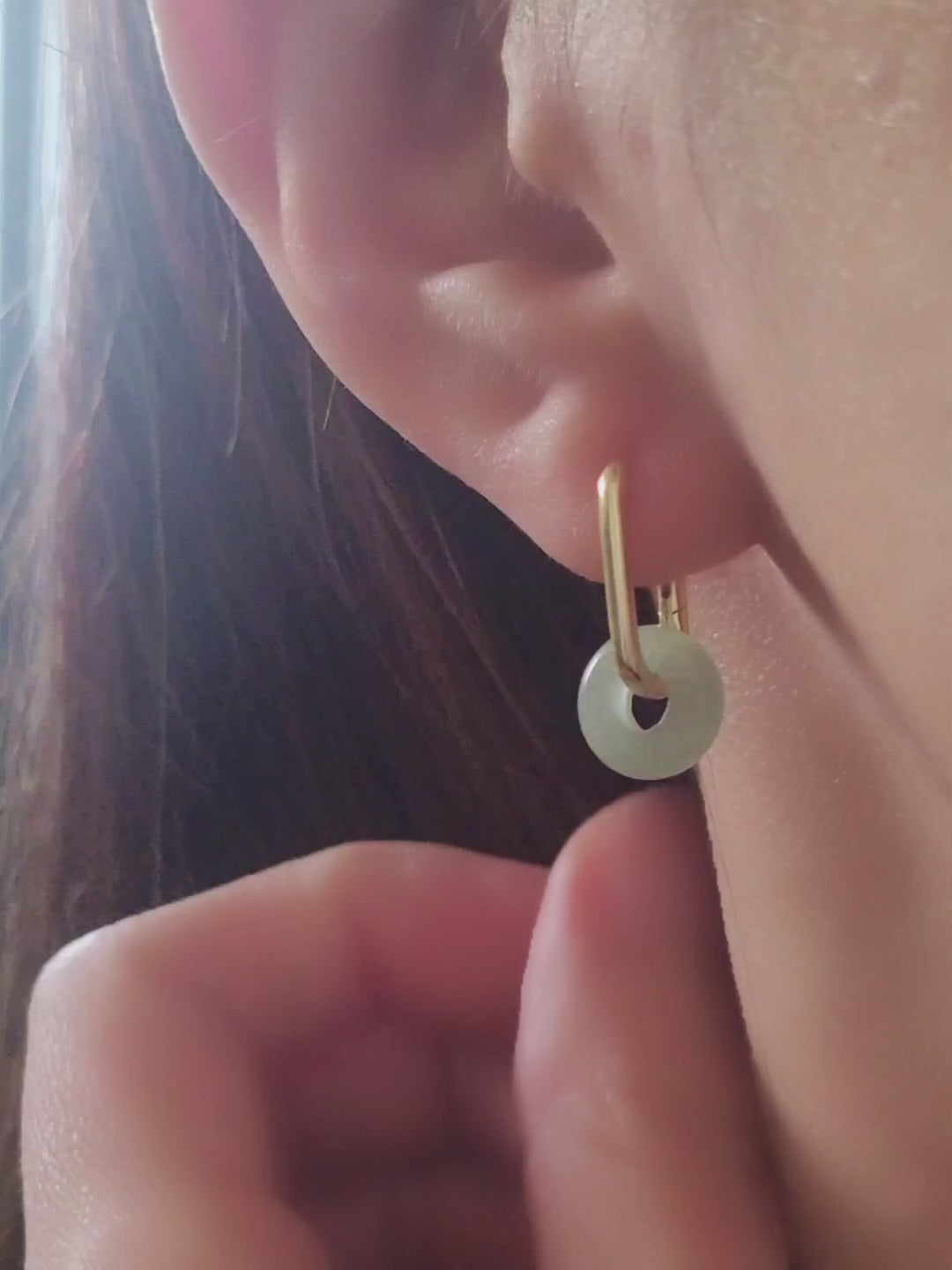 Close-up of a pair of green jade link hoop earrings, showcasing their elegant and minimalist design.