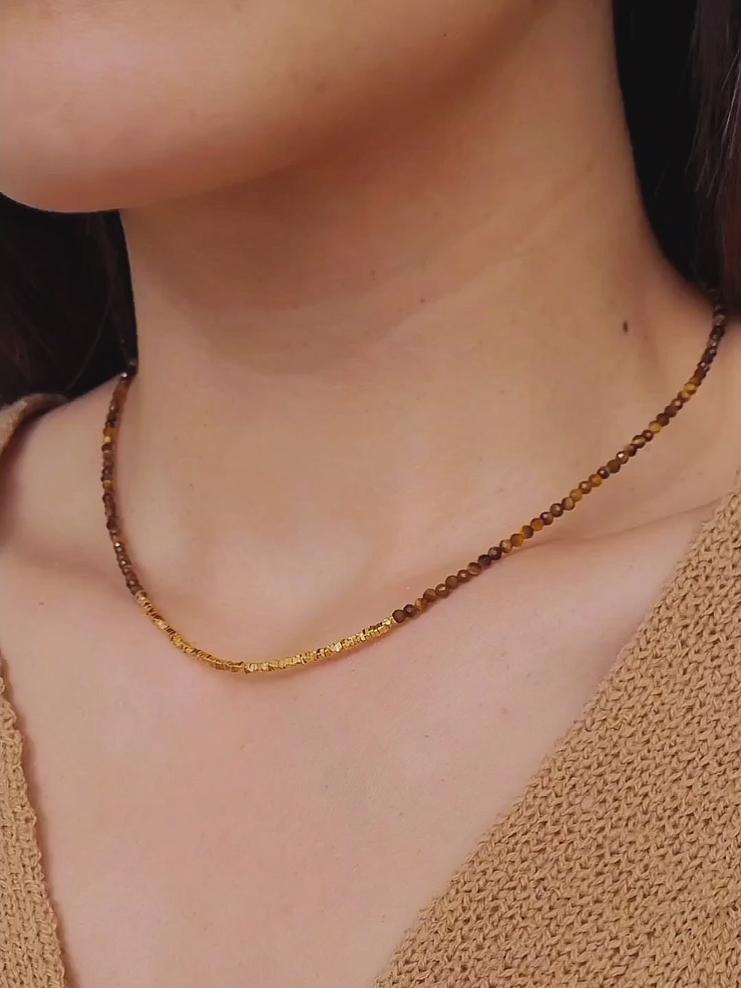 Close-up of woman wearing Tiger’s Eye gemstone choker necklace with 22K gold vermeil nugget beads in natural sunlight