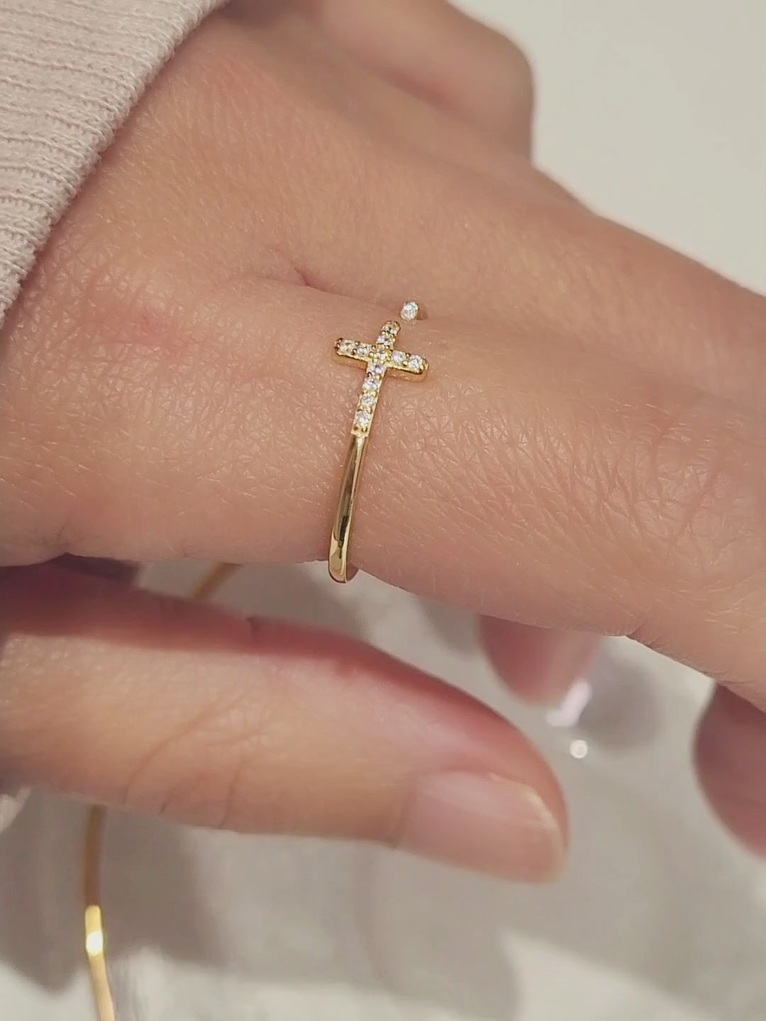 Elegant gold Cross ring adorned with brilliant zircons, showcasing timeless beauty and sophistication.